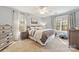 Light filled main bedroom featuring a ceiling fan, carpeted floors and and nightstands at 7025 Ridgeway Rd, Stanley, NC 28164