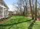 Spacious green backyard featuring a screened-in porch, perfect for outdoor entertaining and relaxation at 800 Water Wheel Ct, Charlotte, NC 28209