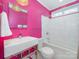 Pink bathroom featuring unique vanity and bathtub-shower combo at 800 Water Wheel Ct, Charlotte, NC 28209