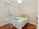 Cozy bedroom featuring wood floors and a window with backyard view at 800 Water Wheel Ct, Charlotte, NC 28209