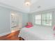 Bright bedroom featuring hardwood floors, natural light, and an ensuite bathroom at 800 Water Wheel Ct, Charlotte, NC 28209