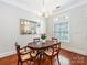 Dining room with hardwood floors, a chandelier, and a large mirror above the table at 800 Water Wheel Ct, Charlotte, NC 28209