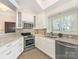 Modern kitchen with stainless steel appliances, granite countertops and subway tile backsplash at 800 Water Wheel Ct, Charlotte, NC 28209