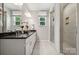 Bright bathroom with a double vanity, granite countertop, and a glass-enclosed walk-in shower at 8637 Miles Gap Rd, Indian Land, SC 29707