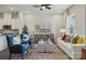 Bright and airy living room with blue accent chairs, white sofa, and view into kitchen with white cabinets at 8637 Miles Gap Rd, Indian Land, SC 29707