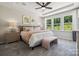 Primary bedroom with a tray ceiling, large windows, and a neutral color palette at 8639 Miles Gap Rd, Indian Land, SC 29707