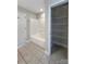 Bathroom featuring shower-tub combo and wire shelving at 9530 Driftwood Ct, Hickory, NC 28601