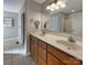 Bathroom featuring double sinks, vanity cabinet, and large mirror at 9530 Driftwood Ct, Hickory, NC 28601