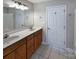 Bathroom featuring double sinks, vanity cabinet, and large mirror at 9530 Driftwood Ct, Hickory, NC 28601