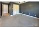 Neutral carpeted bedroom with a closet and an adjacent room, ideal for versatile use at 9530 Driftwood Ct, Hickory, NC 28601