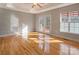 Bright bedroom with hardwood floors, tray ceiling, and access to an outdoor deck at 9530 Driftwood Ct, Hickory, NC 28601