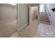 Hallway connecting to a carpeted living space, a closet and stairs to the upper level at 9530 Driftwood Ct, Hickory, NC 28601