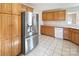 Spacious kitchen featuring stainless steel refrigerator and oak cabinets at 9530 Driftwood Ct, Hickory, NC 28601