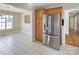 Bright eat-in kitchen with stainless steel refrigerator and tiled floor overlooking dining area at 9530 Driftwood Ct, Hickory, NC 28601