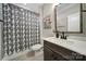 Well-lit bathroom with a patterned shower curtain, modern vanity, and clean fixtures at 9762 Verdun Ct, Indian Land, SC 29707