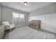 Serene Bedroom featuring a rocking chair and ample natural light at 9762 Verdun Ct, Indian Land, SC 29707