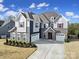 Beautiful two-story home with stone accents, three-car garage and professionally landscaped front yard at 9762 Verdun Ct, Indian Land, SC 29707