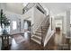 Spacious foyer with wood floors, staircase with iron railing and modern decor at 9762 Verdun Ct, Indian Land, SC 29707