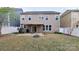 Backyard featuring a patio, fire pit, and a two-story home with lots of windows at 1007 Equipoise Dr, Indian Trail, NC 28079