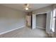 Well-lit bedroom with carpet flooring, closet space, and neutral walls, offering a versatile space at 1007 Equipoise Dr, Indian Trail, NC 28079