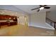 Open-concept space showcases a modern kitchen flowing into a well-lit living area with wood-look floors and staircase at 1007 Equipoise Dr, Indian Trail, NC 28079