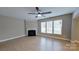 Inviting living room with a cozy fireplace, large windows for natural light, and wood-look flooring at 1007 Equipoise Dr, Indian Trail, NC 28079