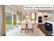 Sunlit dining area adjacent to the kitchen, featuring a sliding glass door and contemporary decor at 1010 Merganser Way, Indian Trail, NC 28079