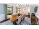 Elegant dining room with large windows, stylish chandelier, and seating for eight at 1010 Merganser Way, Indian Trail, NC 28079