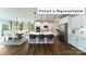 Spacious, modern kitchen with stainless steel appliances, an island with seating, and an adjacent dining area at 1010 Merganser Way, Indian Trail, NC 28079