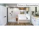 Bathroom featuring a glass enclosed shower and separate soaking tub under a window at 1037 Merganser Way, Indian Trail, NC 28079