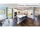 Modern kitchen with a large island, quartz countertops, stainless steel appliances, and ample cabinet space at 1037 Merganser Way, Indian Trail, NC 28079