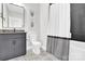 Stylish bathroom with patterned tile floor, floating vanity, toilet, and shower with curtain at 11327 James Coy Rd, Davidson, NC 28036
