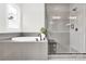 Modern bathroom with a sleek soaking tub, tiled shower, and elegant fixtures for a spa-like experience at 11327 James Coy Rd, Davidson, NC 28036