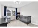 Bedroom featuring a crib, arcade machine, and large window at 11327 James Coy Rd, Davidson, NC 28036