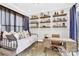 Cozy bedroom with built-in shelving and a comfortable daybed, perfect for relaxation or a home office at 11327 James Coy Rd, Davidson, NC 28036