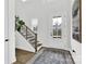 Bright foyer featuring hardwood floors, a modern staircase, and a stylish front door with glass panes at 11327 James Coy Rd, Davidson, NC 28036