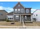 Charming two-story home featuring gray siding, white trim, and a welcoming front porch at 11327 James Coy Rd, Davidson, NC 28036