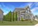 Gray townhouse showcasing modern architectural design and manicured landscaping in a desirable community at 11327 James Coy Rd, Davidson, NC 28036