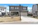 A two-story home with gray siding, a front-facing garage, and manicured lawn at 11327 James Coy Rd, Davidson, NC 28036