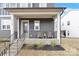 Charming front porch features seating area, railing, and stylish front door at 11327 James Coy Rd, Davidson, NC 28036