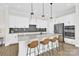 Modern kitchen features stainless steel appliances, large island with seating, and stylish pendant lighting at 11327 James Coy Rd, Davidson, NC 28036