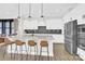 Bright kitchen with white cabinets, a spacious island with barstool seating, and wood-look flooring at 11327 James Coy Rd, Davidson, NC 28036