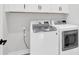 Bright laundry room equipped with modern, front load washer and dryer at 11327 James Coy Rd, Davidson, NC 28036