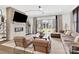 Sunlit living room features a stylish brick fireplace, cozy seating, and access to outdoor space at 11327 James Coy Rd, Davidson, NC 28036