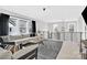 Upstairs living room with modern railing, large windows, and plush white sofas, perfect for relaxation at 11327 James Coy Rd, Davidson, NC 28036