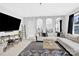 Bright upstairs living area with a large TV, stylish decor, and comfortable sectional sofa and open staircase at 11327 James Coy Rd, Davidson, NC 28036
