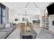 Open-concept living room boasts modern decor, a fireplace, and seamless transition to kitchen and dining areas at 11327 James Coy Rd, Davidson, NC 28036
