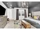 Comfortable main bedroom featuring a dark gray accent wall, a modern light fixture, and natural lighting at 11327 James Coy Rd, Davidson, NC 28036