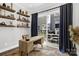 Bright office space featuring custom wood shelving and sliding glass doors to a patio with an outdoor kitchen at 11327 James Coy Rd, Davidson, NC 28036