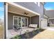 A covered back patio features a ceiling fan and comfortable seating, perfect for relaxation at 11327 James Coy Rd, Davidson, NC 28036